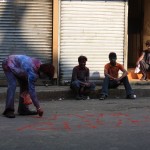 Boy draws Happy Holi on the street