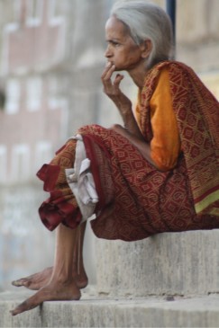 Elderly woman sitting on the ghats of Varanasi