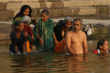 Pilgrims bathing in the sacred waters at sunrise