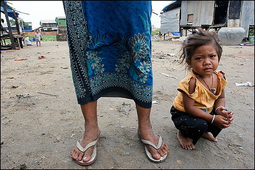 Young girl stands with her mother in Phnom Penh, Cambodia