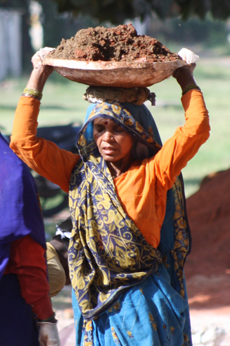 Back-breaking construction work for an Indian woman